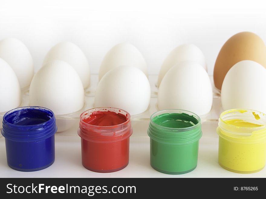 Eggs and paints, preparation for easter on white