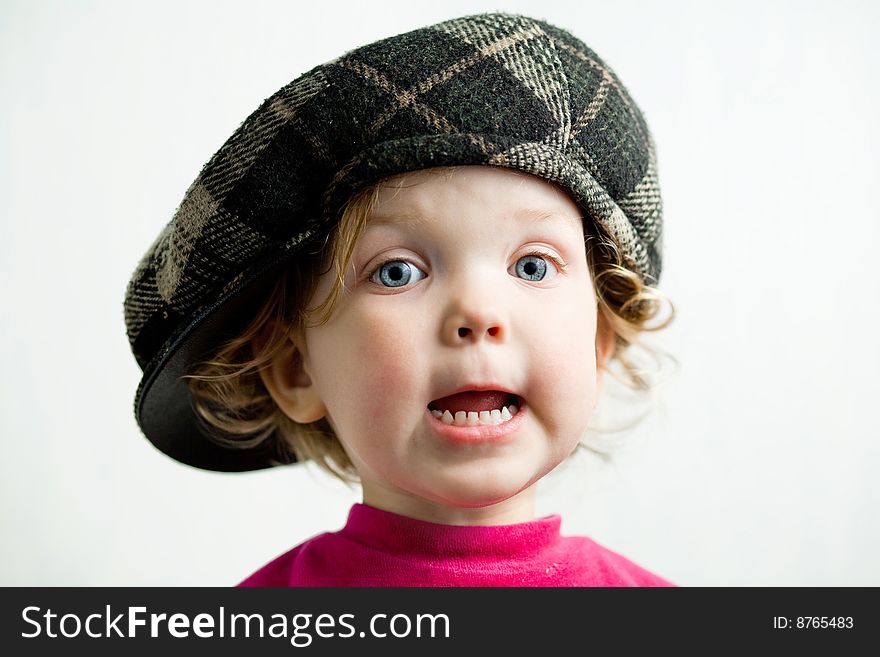 Stock photo: an image of a little girl in brown cap