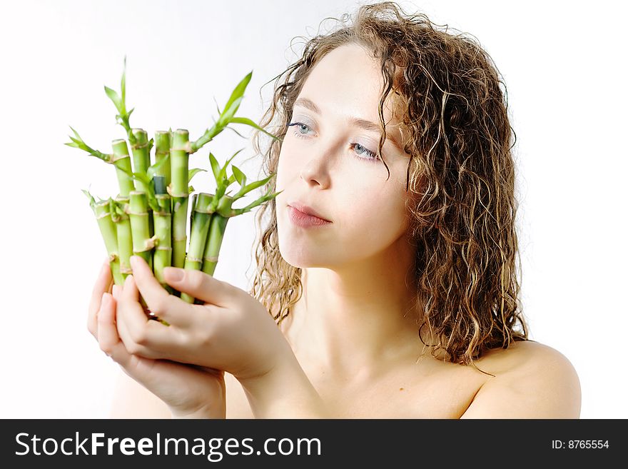 An image of a woman looking at bamboo in her hands. An image of a woman looking at bamboo in her hands