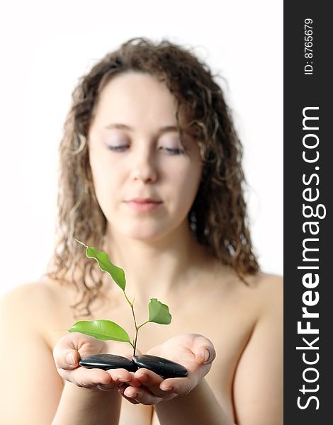 Stock photo: an image of a girl with plant and stones in her hands. Stock photo: an image of a girl with plant and stones in her hands