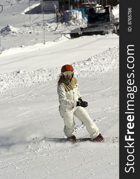 The young girl with the red helmet drove the snowboard on Bulgarian mountains. The young girl with the red helmet drove the snowboard on Bulgarian mountains.