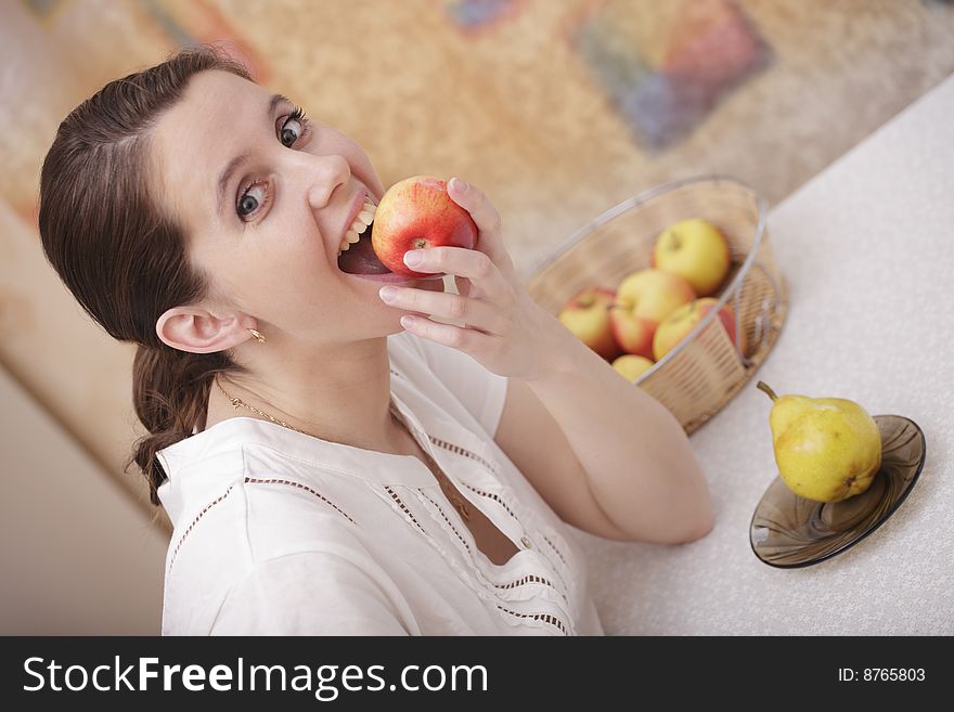 A photo of young girl eating an apple. A photo of young girl eating an apple