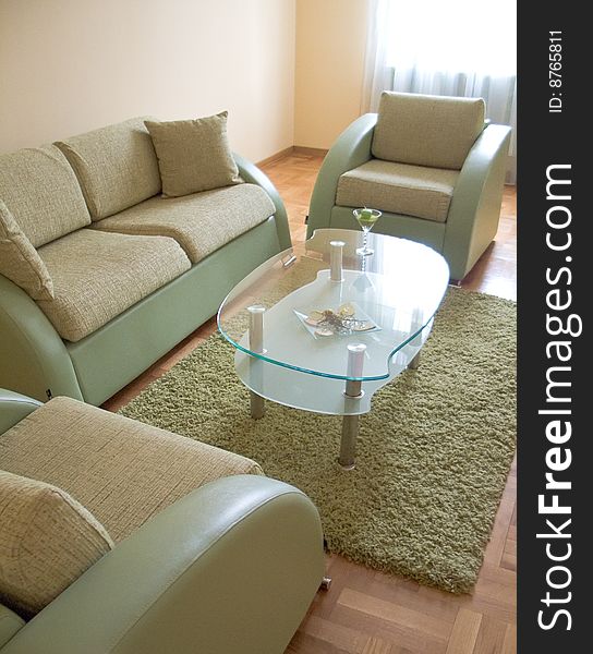 Room interior with couch, table and chairs