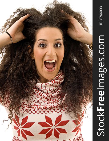 Beautiful woman shouting and holding her hairs on an isolated white background