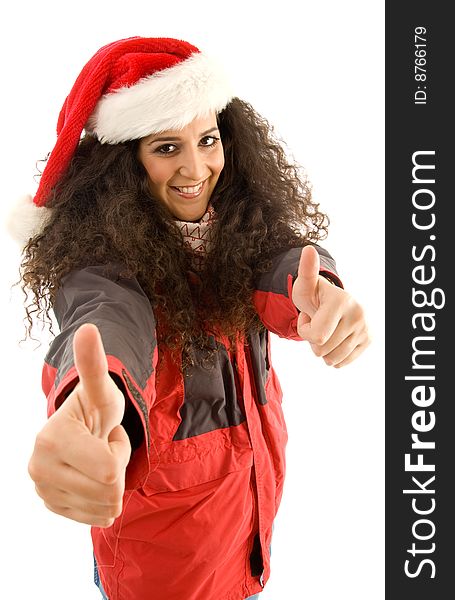 Hispanic female wearing christmas hat and showing thumbs up against white background