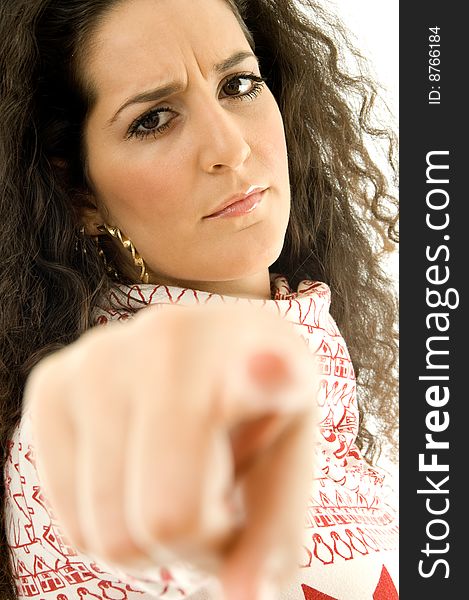 Beautiful angy woman pointing towards on an isolated white background. Beautiful angy woman pointing towards on an isolated white background