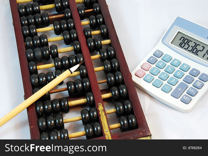 Traditional Chinese calculation tool-Abacus with a brush and a calculator. Traditional Chinese calculation tool-Abacus with a brush and a calculator