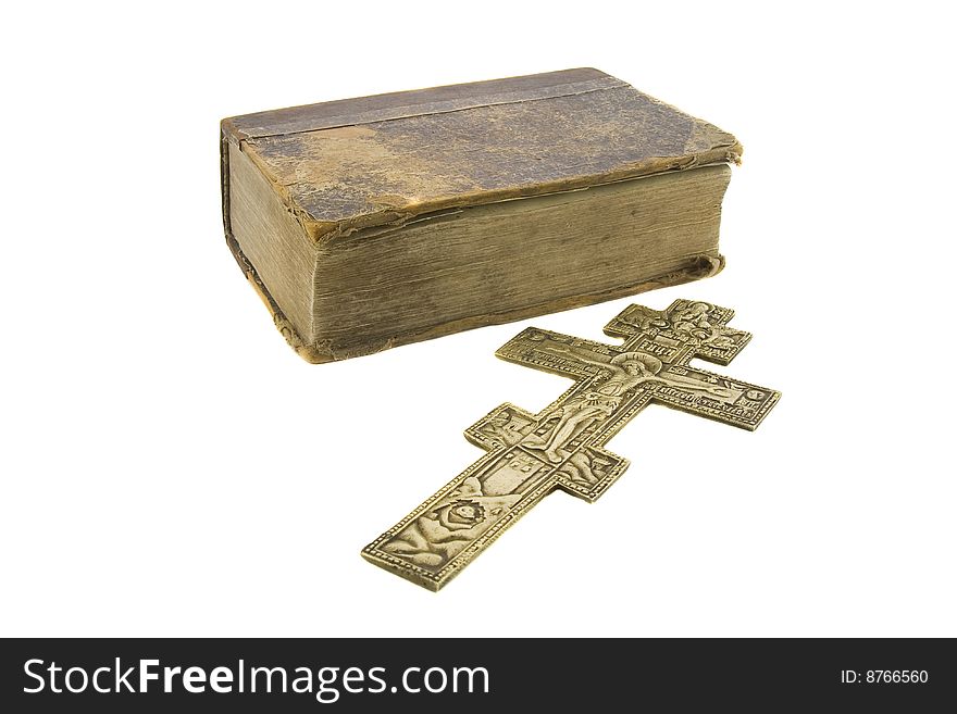 Very old vintage bible and big church cross near to it isolated over white background