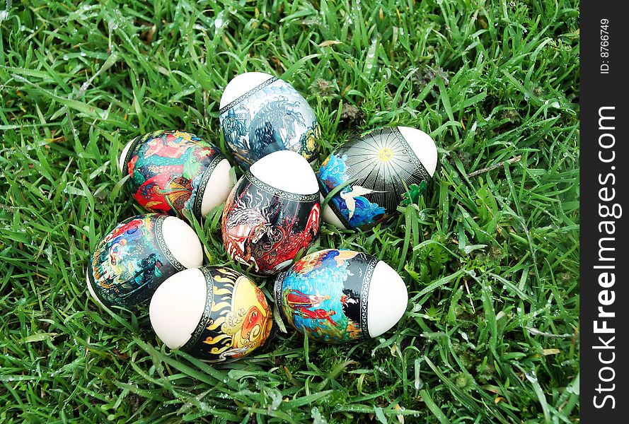 On a green grass Easter eggs lie