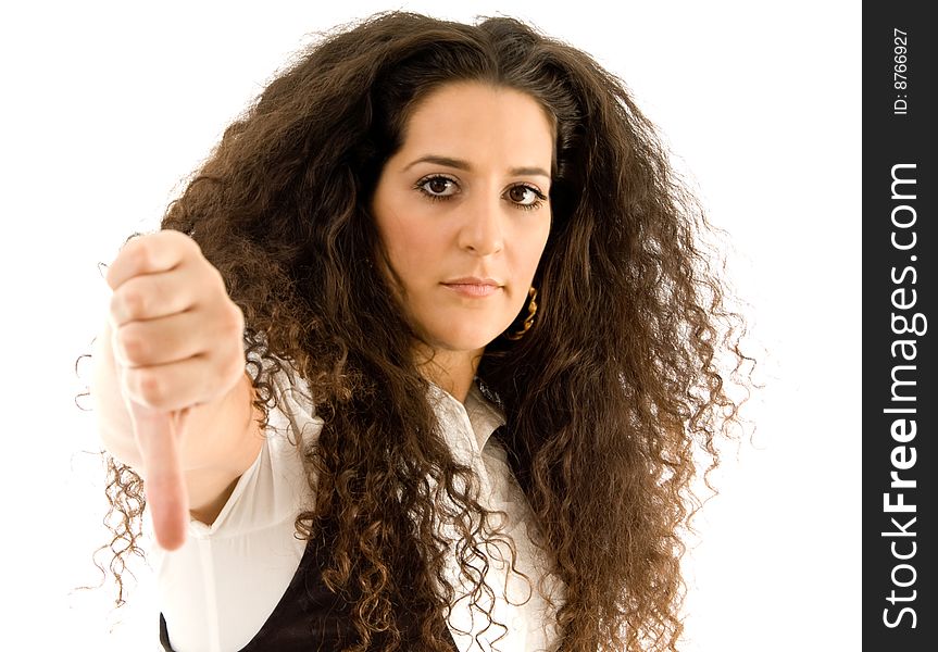 Hispanic female showing thumbs down against white background
