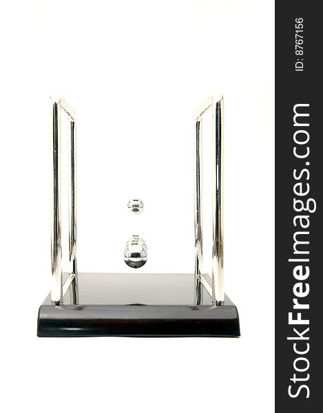 Perpetuum mobile with one ball in air against white background