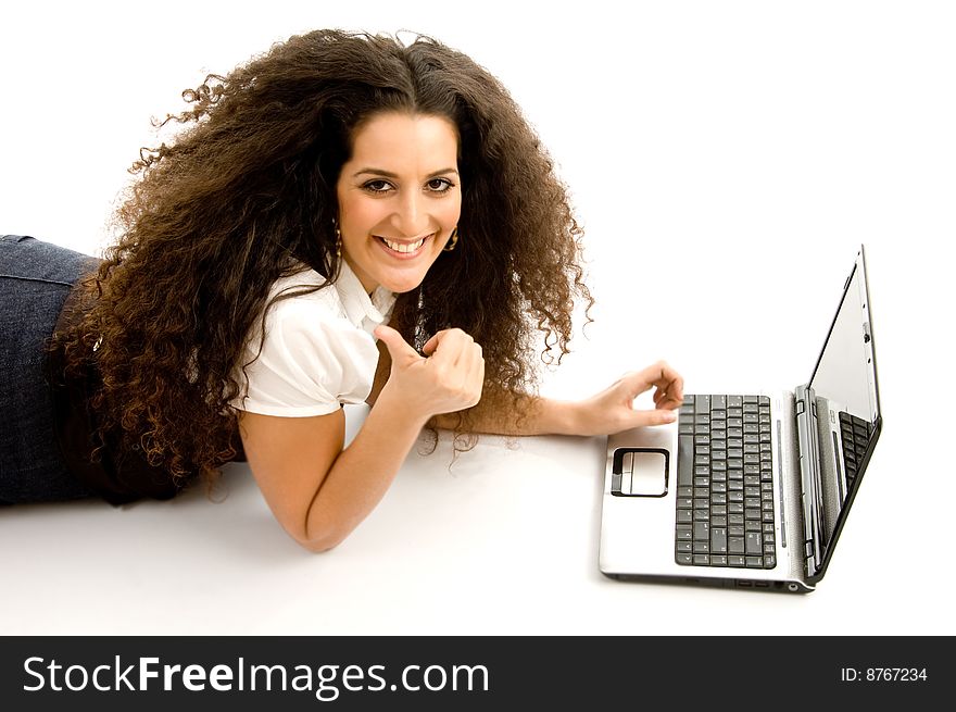 Beautiful woman showing thumbs up and working on laptop on an isolated white background