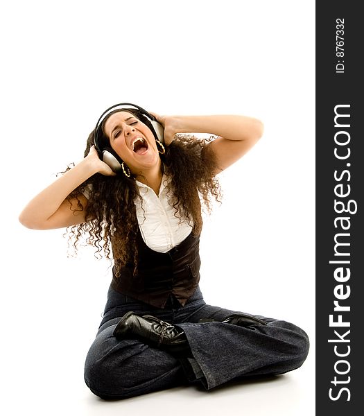 Young woman listening to music wih headphones on an isolated background