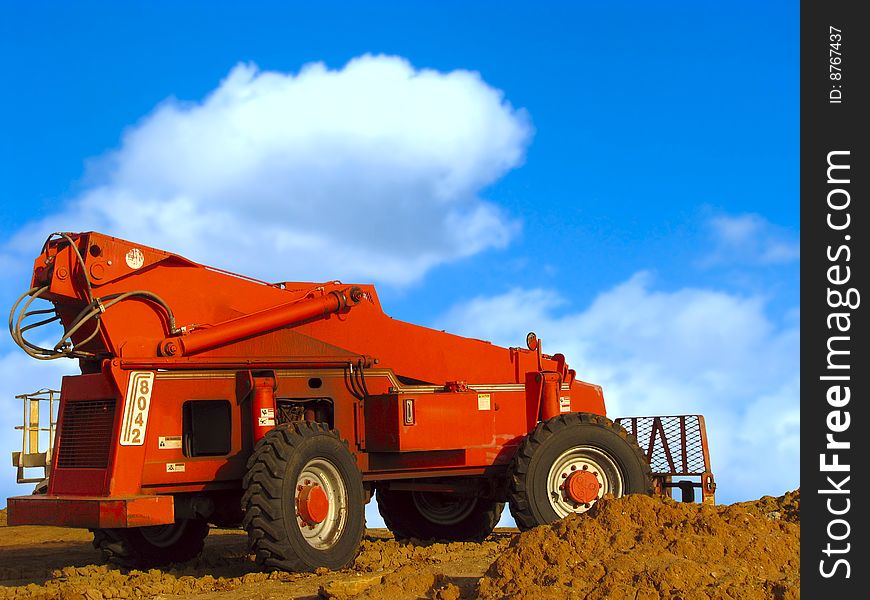 Bulldozer in action under blue sky. Bulldozer in action under blue sky.