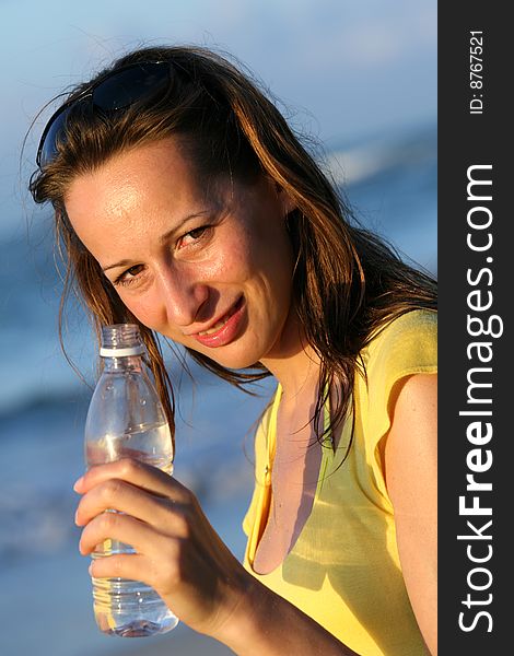 Woman holding a bottle water in her hand. Woman holding a bottle water in her hand