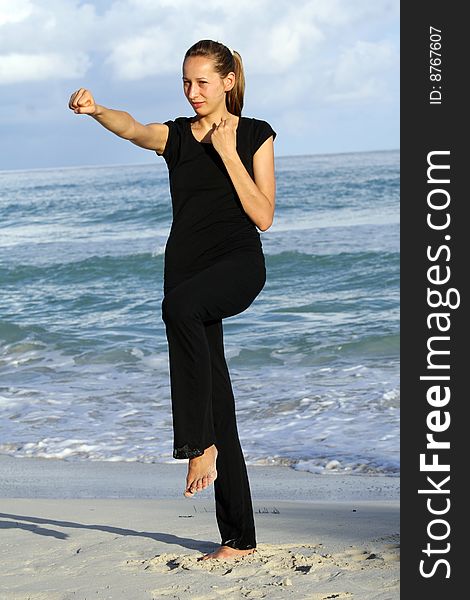 Woman doing fitness exercises on the beach. Woman doing fitness exercises on the beach