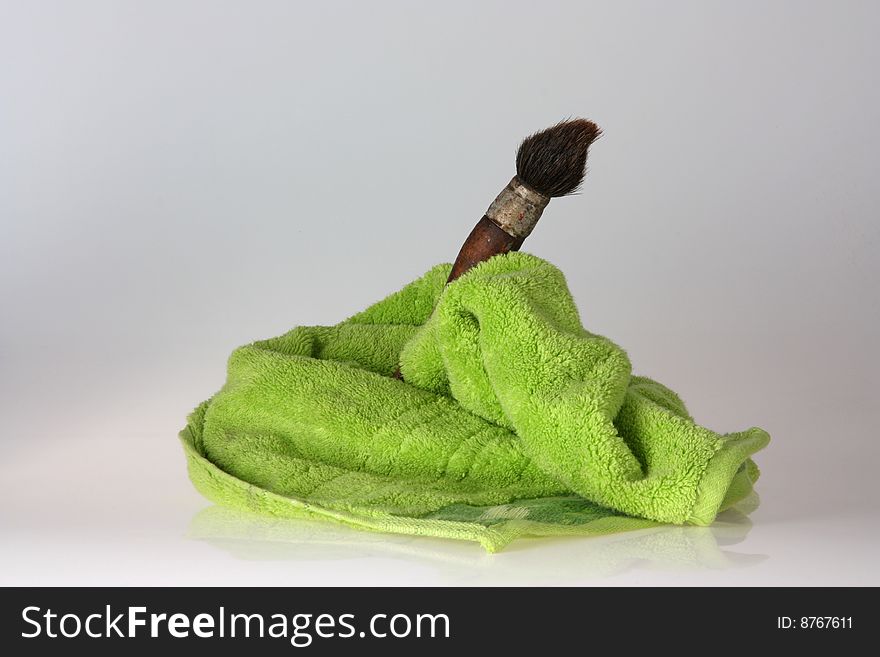 Brush with green towel and blurred background