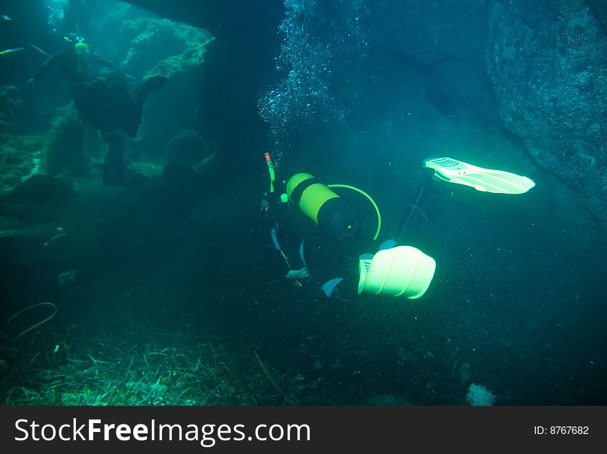 Diver in the mediterranean sea in a cave. Diver in the mediterranean sea in a cave.