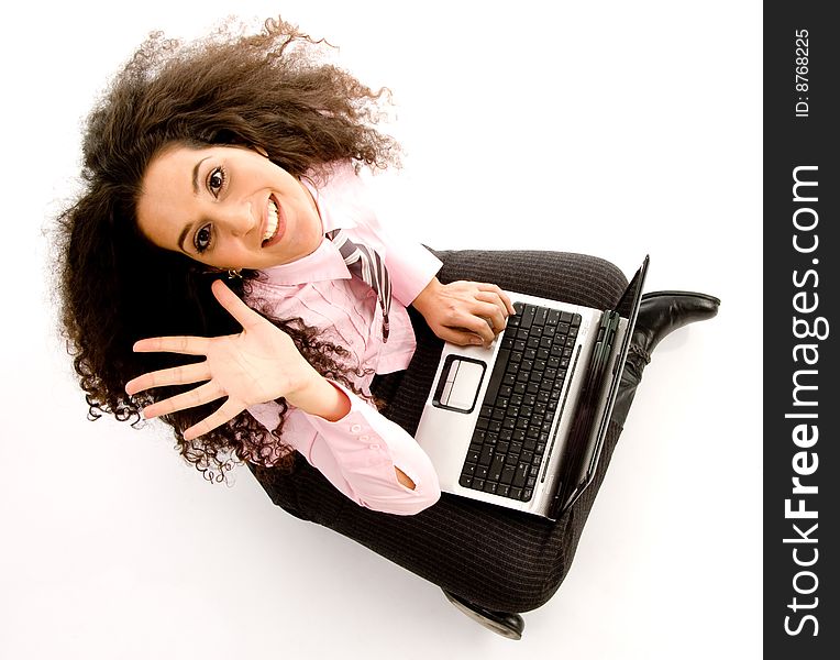 Young hispanic female busy working on laptop on an isolated background