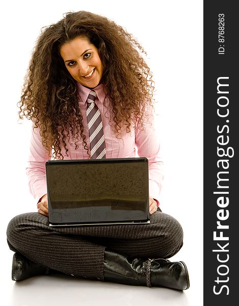 Young hispanic female busy working on laptop on an isolated background