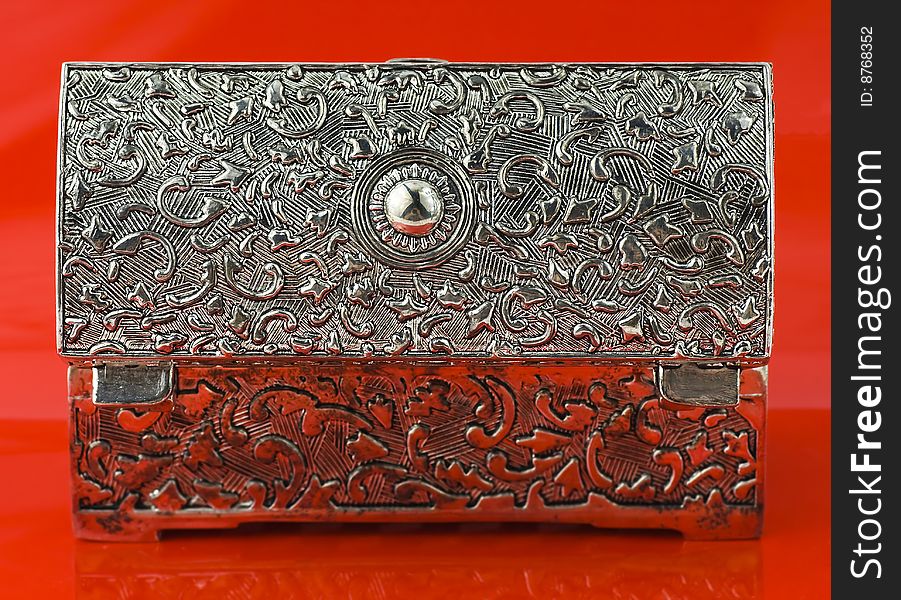 Open silver box isolated on red background. Open silver box isolated on red background