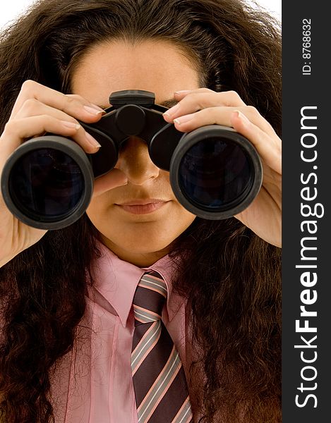 Young corporate woman viewing through binoculars against white background