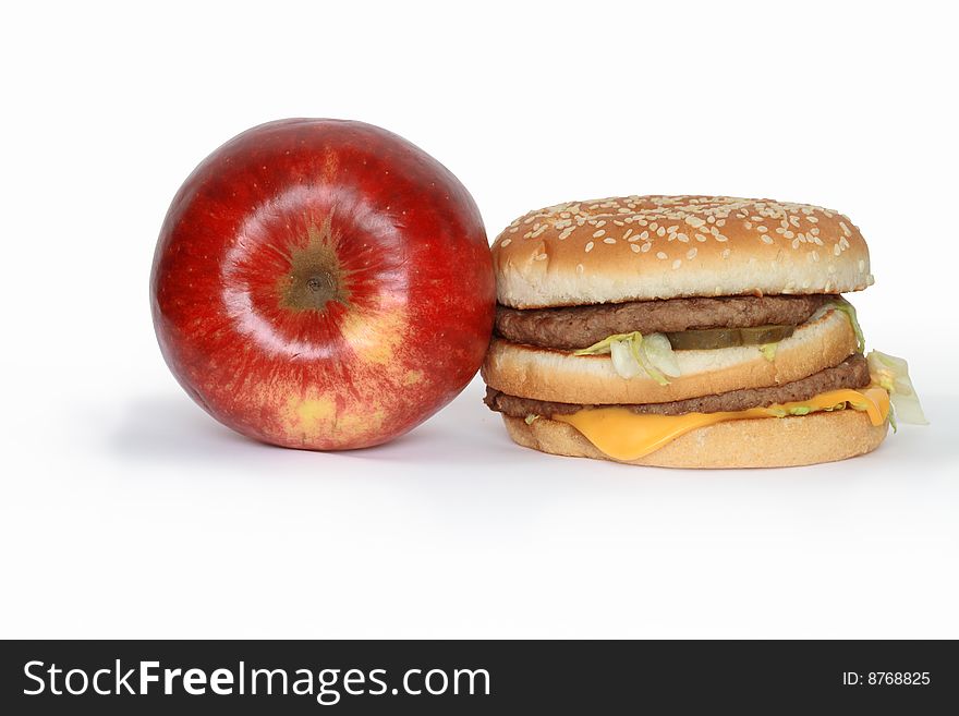 Red apple and hamburger isolated on white background. Red apple and hamburger isolated on white background