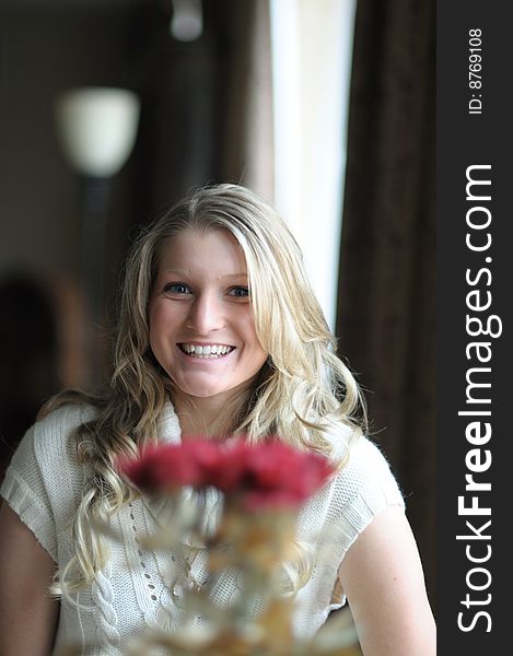 Attractive bond teen behind flowers. Attractive bond teen behind flowers