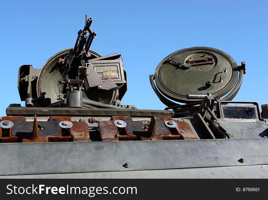 Military gun machine isolated on blue