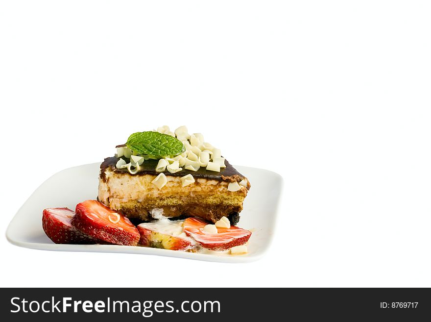 Piece of cake with white chocolate, strawberries and cream, isolated on white