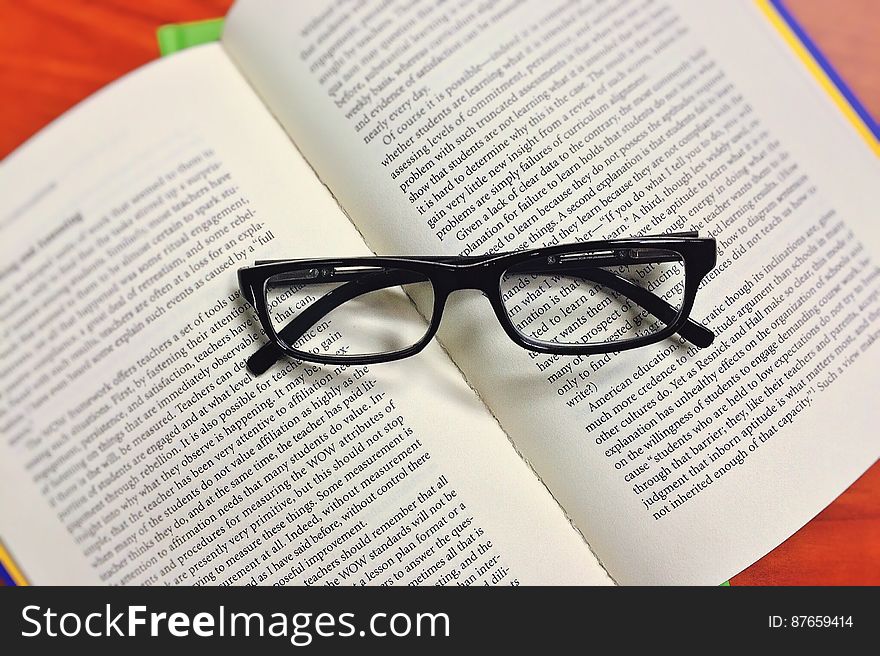 Black Framed Eyeglasses on Book