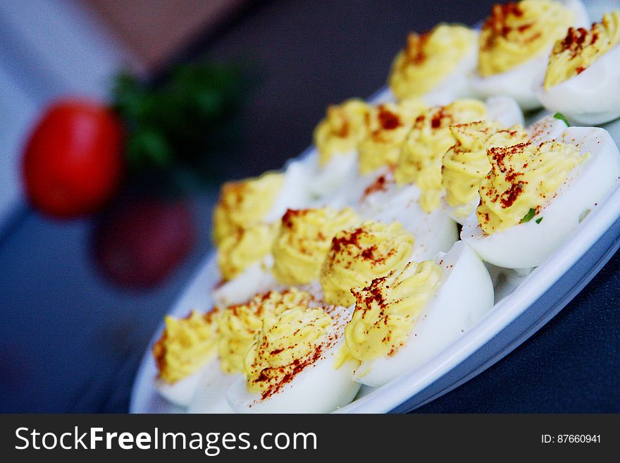 A close up of a plate of deviled eggs. A close up of a plate of deviled eggs.