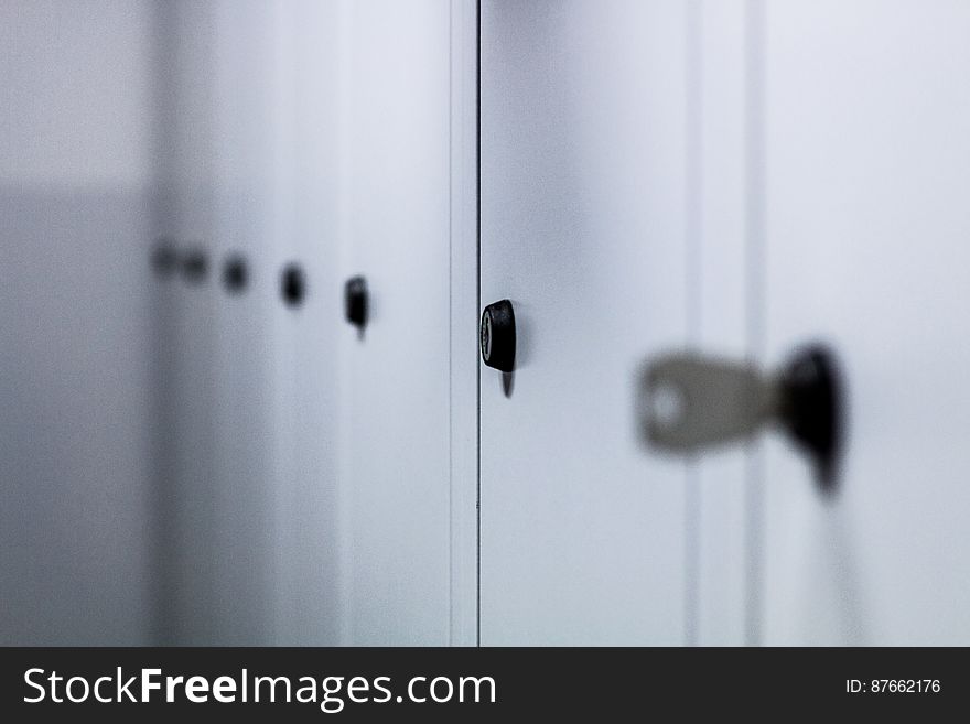 Row of white painted closed lockers. Row of white painted closed lockers.