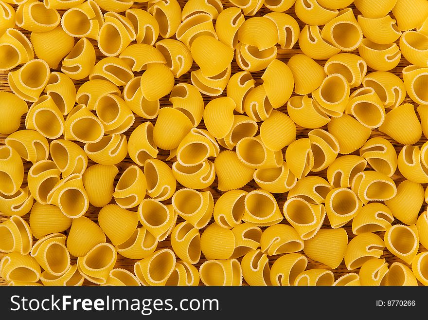 Yellow raw pasta textured background. Yellow raw pasta textured background