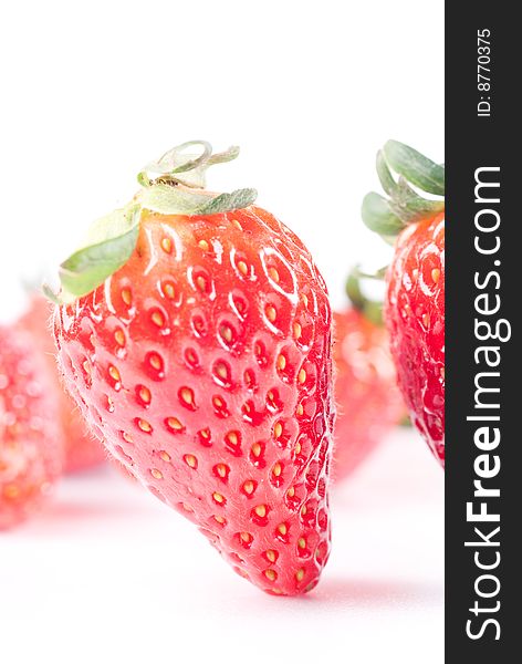 Fresh juicy standing strawberry isolated on white