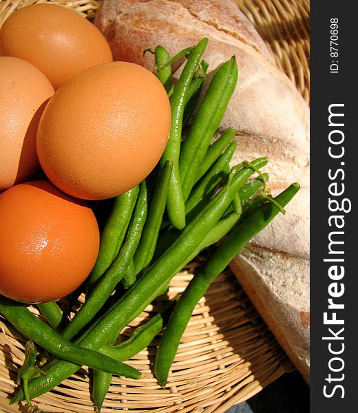 Close up photo of a Basket of fresh eggs, beans and bread. Close up photo of a Basket of fresh eggs, beans and bread.