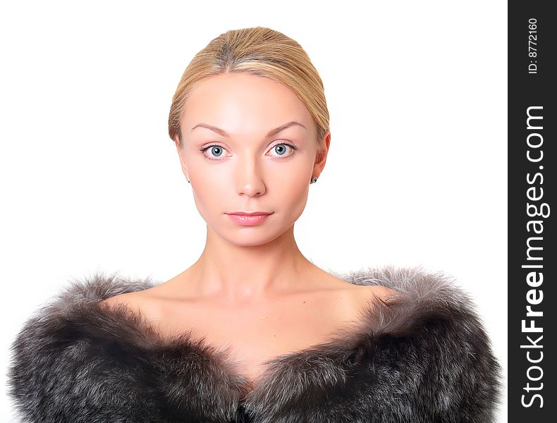 Portrait of the beautiful blonde with fur on shoulders, isolated on a white background, please see other photos of this series. Portrait of the beautiful blonde with fur on shoulders, isolated on a white background, please see other photos of this series