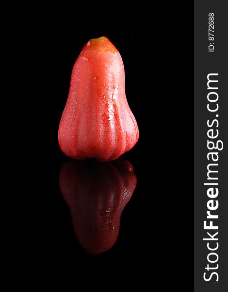 A water apple isolated on black background.