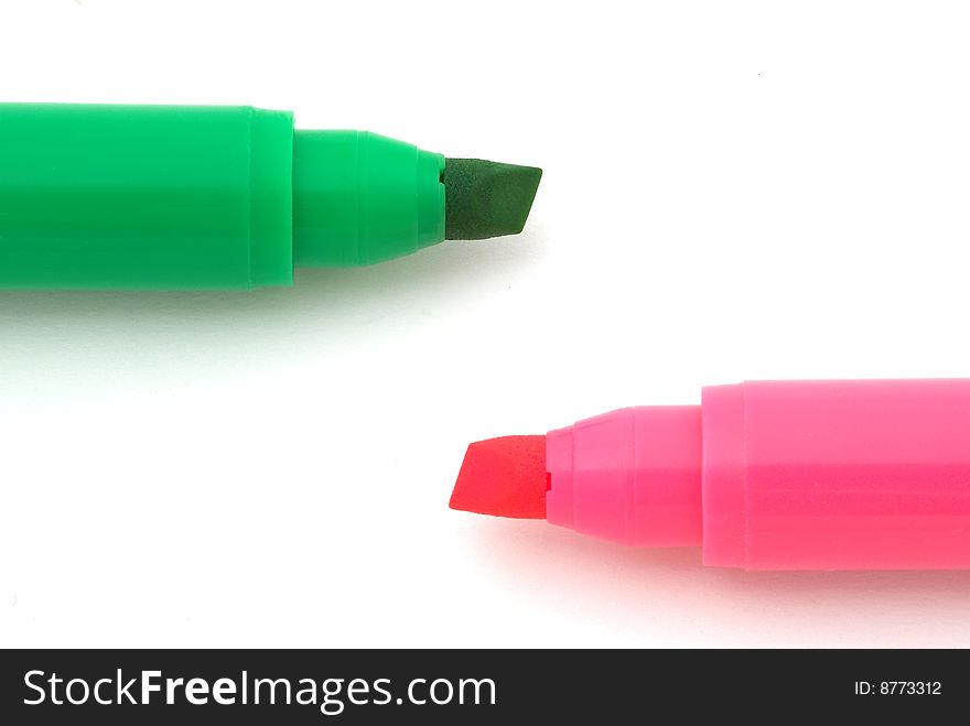 Red and green pens on the white background. Selective focus