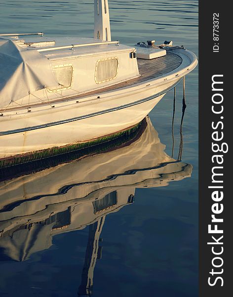 White boat and its reflection on sea surface. White boat and its reflection on sea surface.