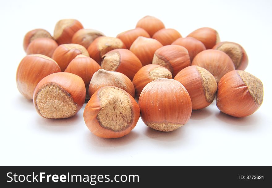 Hazelnuts over the white background