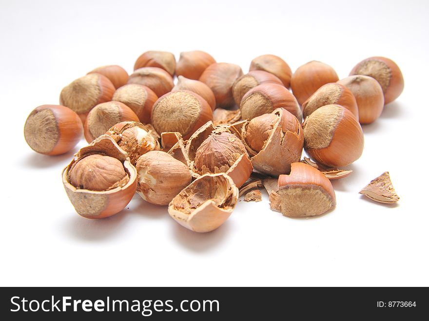 Hazelnuts over the white background