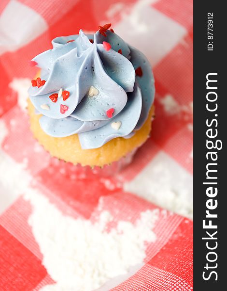 Delicious cupcake on a red table cloth. Delicious cupcake on a red table cloth