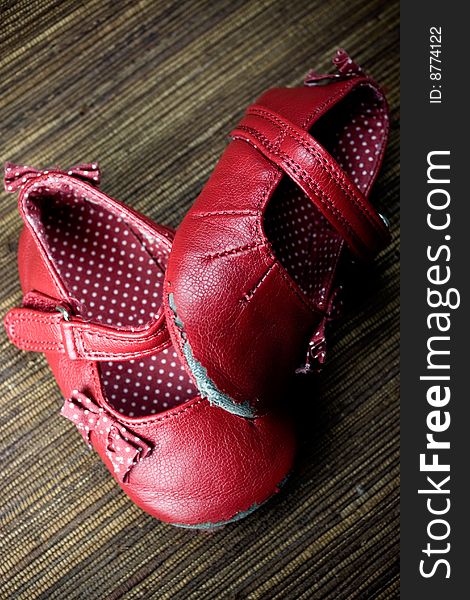 Worn and dirty red baby girl shoes. Worn and dirty red baby girl shoes