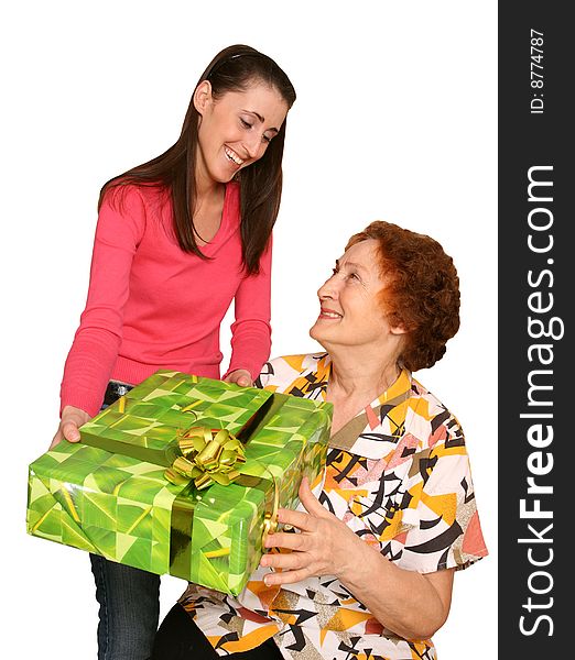 The young girl gives a greater holiday box with a bow elderly the signor. The young girl gives a greater holiday box with a bow elderly the signor