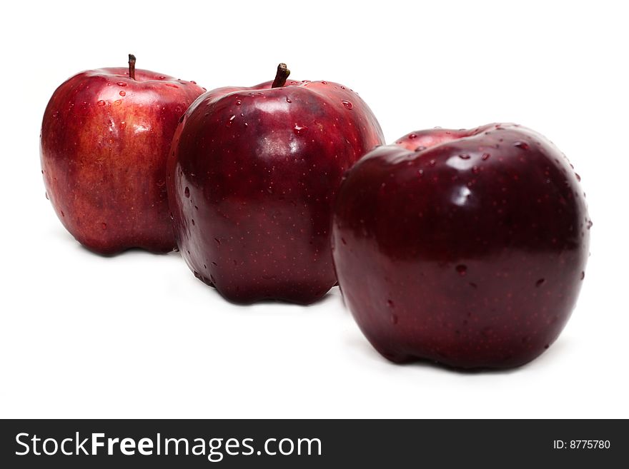 Three red apples, in droplet grow insulated on white background