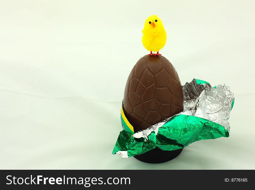 Close-up of easter chocolate egg  with yellow chicken. Close-up of easter chocolate egg  with yellow chicken