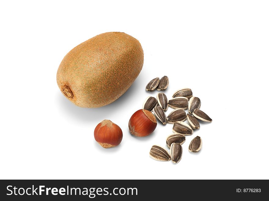 Kiwi and hazelnut isolated on white background