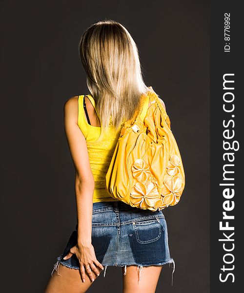 Girl with a bag standing the back