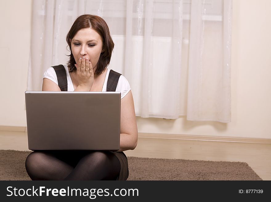 Woman with laptop on carpet